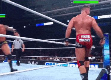 a man in a wrestling ring has austin theory on the back of his shorts