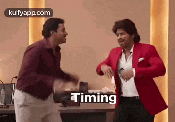 two men are dancing together in a room with the word timing written on the bottom .