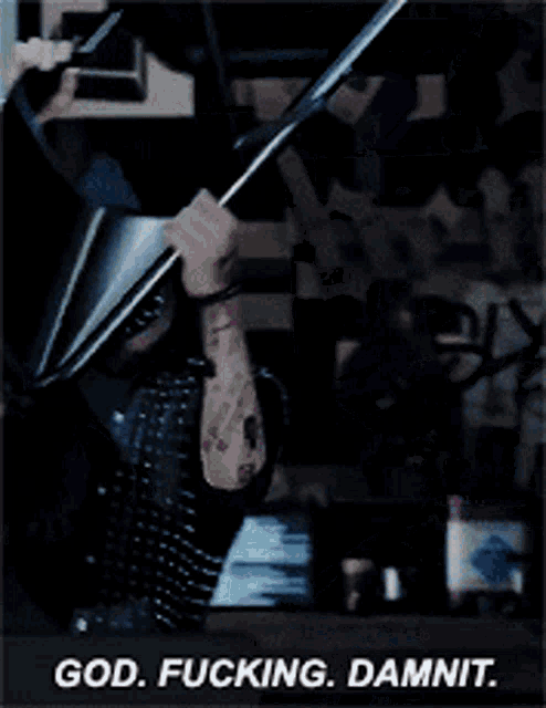 a man with a tattoo on his arm is holding a cone over his head and says god fucking damnit