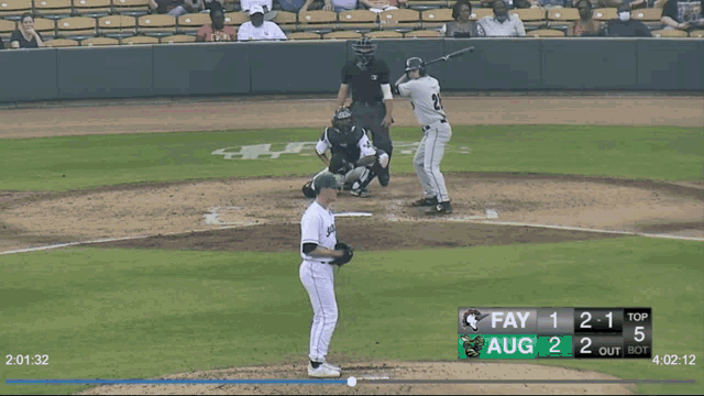 a baseball game is being played and the score is 2 to 1