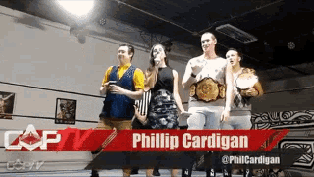 a group of people standing in front of a sign that says phillip cardigan on it