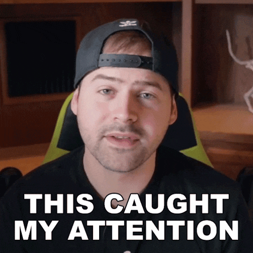 a man wearing a hat says " this caught my attention " while sitting in a chair