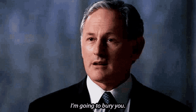 a man in a suit and tie is talking about going to bury you .