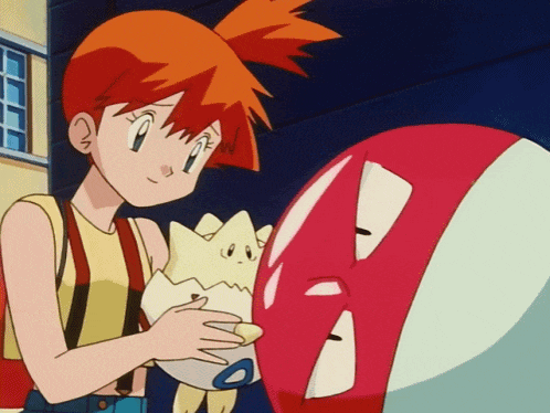 a girl with orange hair is holding a stuffed animal next to a red object