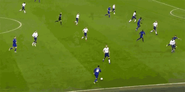 a soccer game is being played on a field with players in white and blue