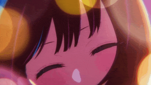 a close up of a girl 's face with her eyes closed .