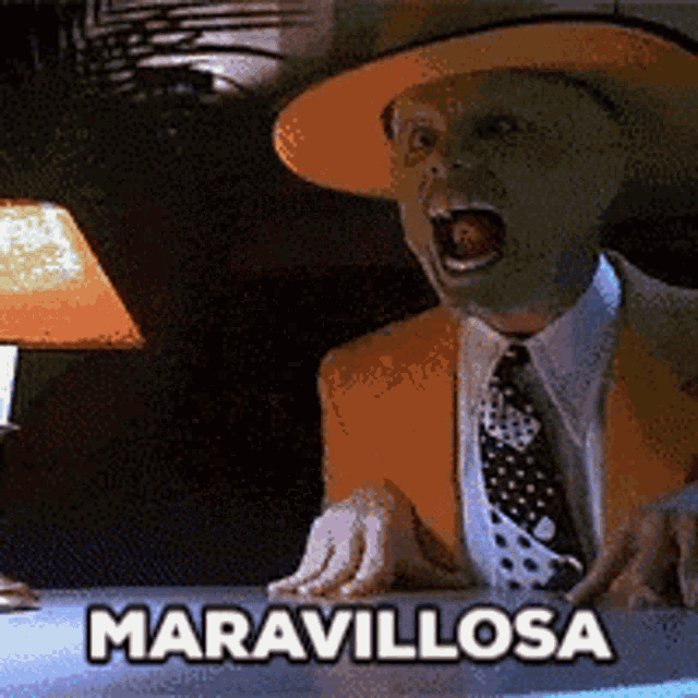 a man wearing a mask and a hat is sitting at a table with the words maravillosa written on it
