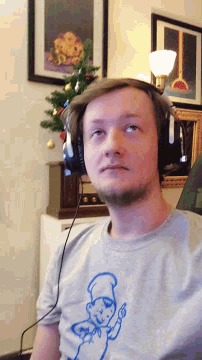 a man wearing headphones and a shirt that has a drawing of a man on it