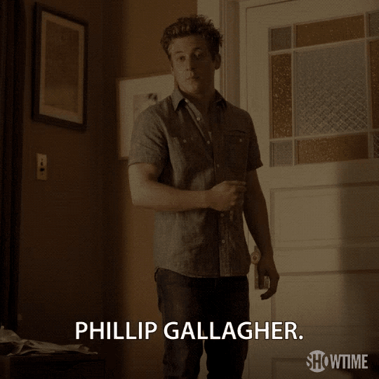 a man standing in front of a door that says phillip gallagher on the bottom