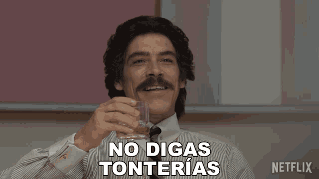 a man with a mustache is holding a glass of whiskey and says no digas tonterias
