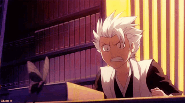 a cartoon character with a book in front of a bookshelf with the hashtag okami-fr