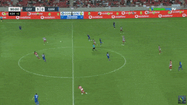 a soccer game is being played on a field with ads for vodafone and cosmote tv