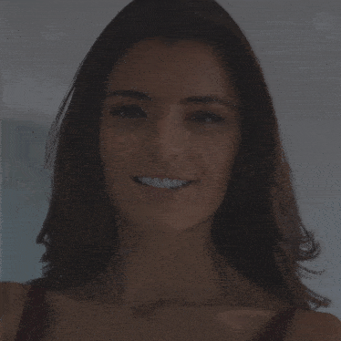 a close up of a woman 's face with a blurred background