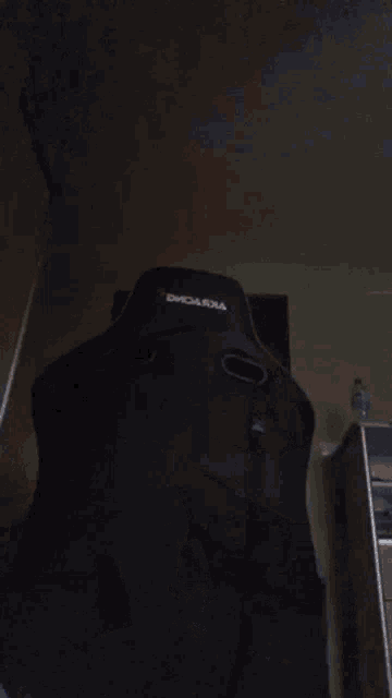 a man wearing a black mask is holding a toy gun