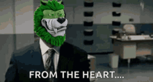 a man in a suit has a green lion mask on his head and the words from the heart