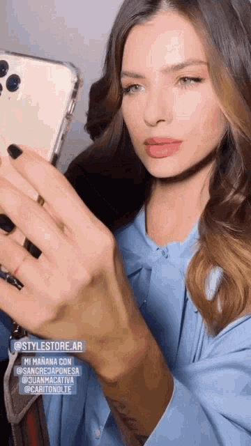 a woman taking a picture of herself with her phone