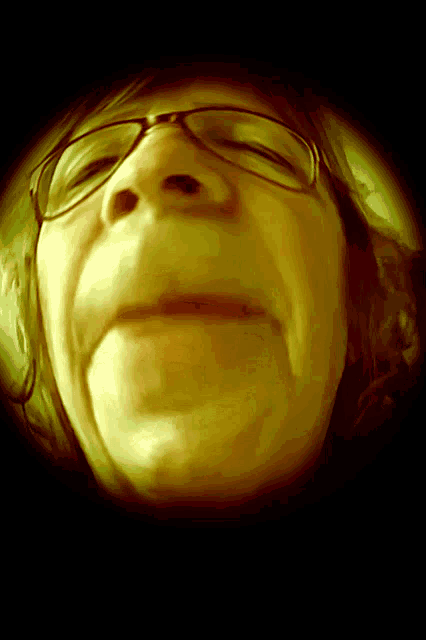 a close up of a woman 's face wearing glasses
