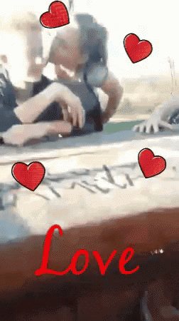 a picture of a couple kissing with the word love in red