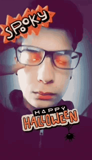 a young man wearing glasses has a spooky happy halloween sticker on his face