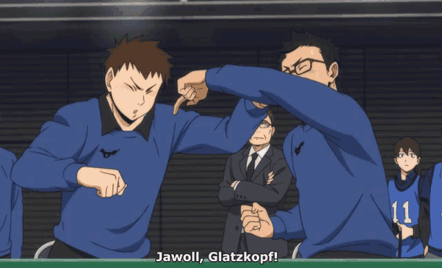 a man in a blue sweater with the number 11 on it stands next to another man