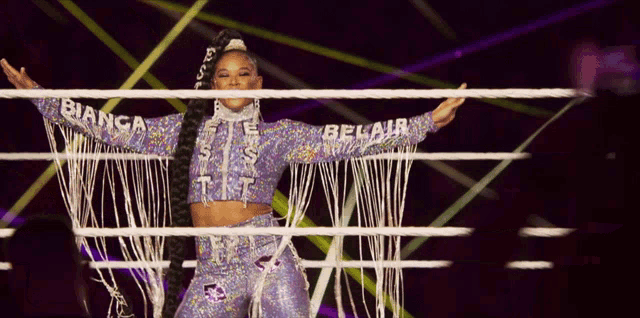a woman stands in a ring with the word belair on her sleeve
