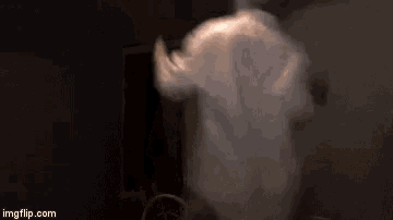 a person is standing in the dark with smoke coming out of their mouth .
