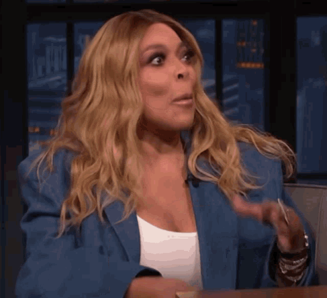 wendy williams is wearing a blue jacket and white shirt