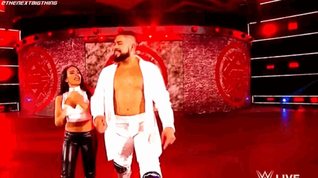 a man and a woman are walking on a stage .