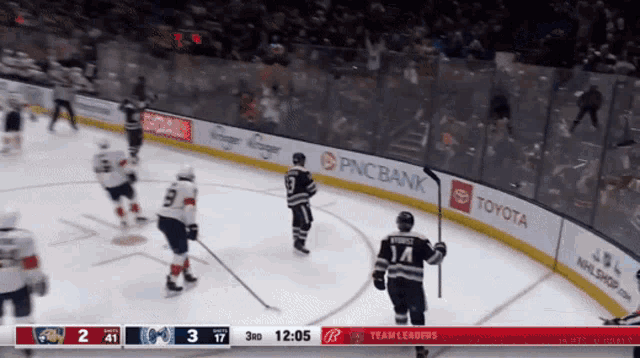 a hockey game is being played in a stadium sponsored by pnc bank toyota and team leaders