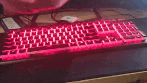 a stuffed animal is laying on top of a laptop keyboard .