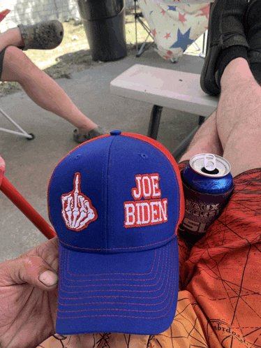 a blue and red hat that says joe biden with a middle finger on it