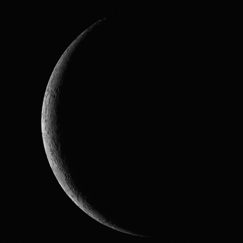a black and white photo of the moon with a dark background