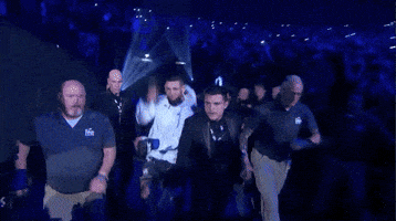 a man in a white jacket with the word ufc on the front