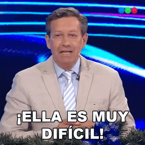 a man in a suit and tie is saying " ella es muy dificil "