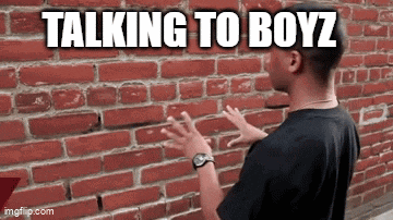 a man is standing in front of a brick wall talking to boyz