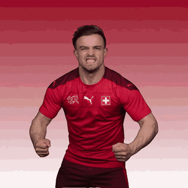 a man wearing a red puma shirt with a swiss flag on it