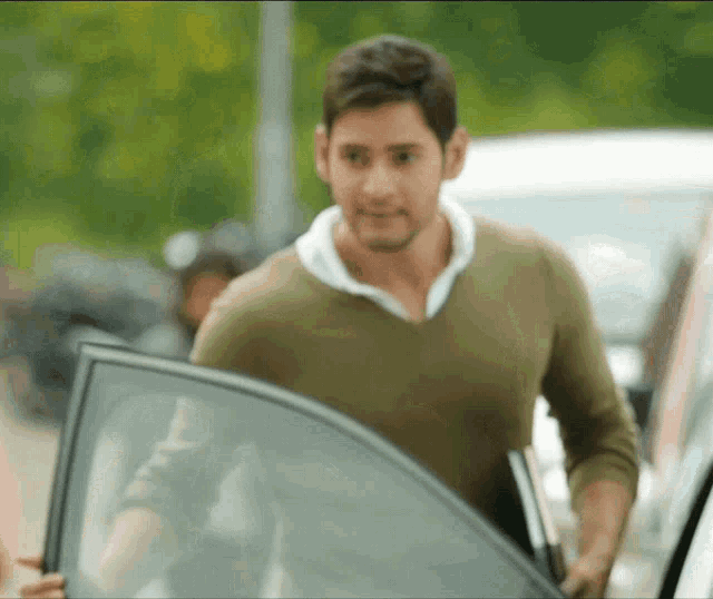 a man is getting out of a car with his door open