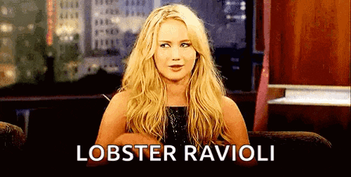 a woman is sitting in a chair with the word lobster ravioli written on the screen .