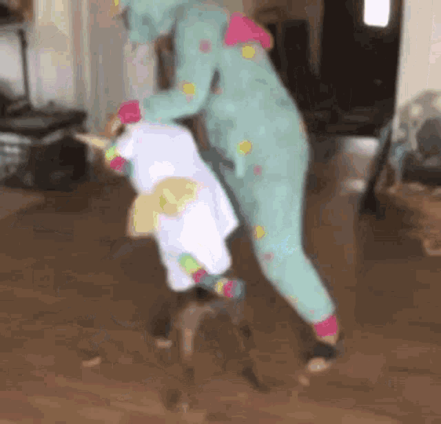 a person in a unicorn costume is standing next to a small dog