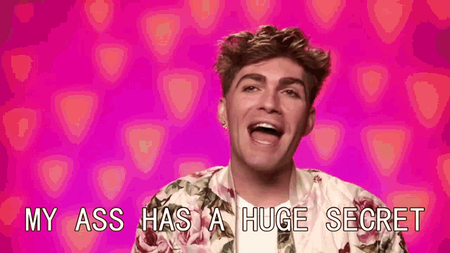 a man in a floral jacket is singing a song with the words `` my ass has a huge secret '' behind him .