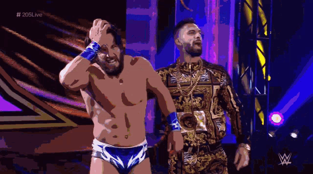 two wrestlers on a stage with the hashtag # 206live on the bottom right