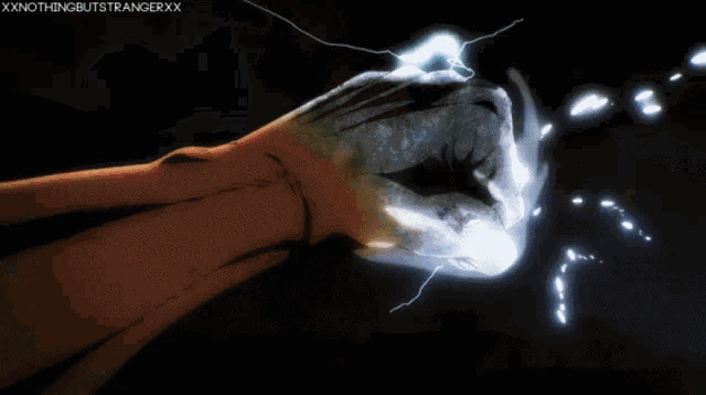 a person 's fist is glowing in the dark with the caption xxxnothingbutstrangerxx