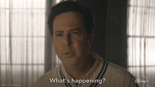 a man says what 's happening while wearing a sweater