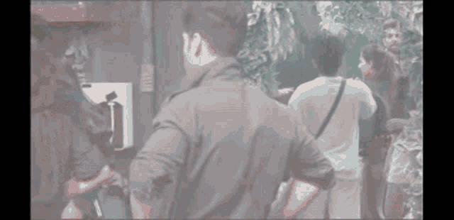 a man and a woman are standing next to each other in a dark room .