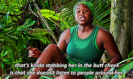 a woman in a green tank top is sitting in the jungle with a caption that says that 's kinda stabbing