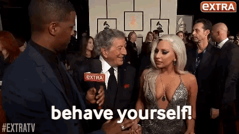 lady gaga is being interviewed on the red carpet and says behave yourself