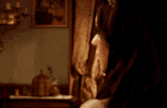 a woman 's face is shown in a dark room