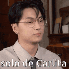 a young man wearing glasses and a tie says solo de carlita