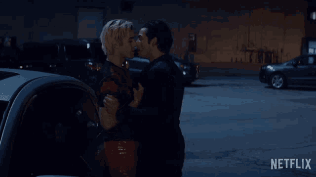 a couple kissing in a parking lot with a netflix logo