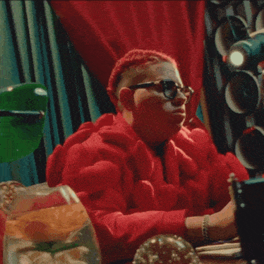 a man in a red jacket smoking a cigarette